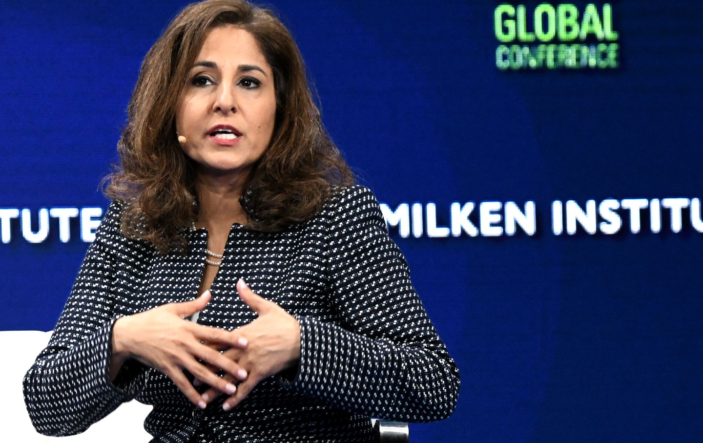 Neera Tanden speaks on stage at the Milken Conference