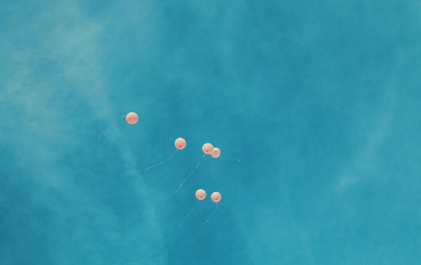 balloons floating in sky