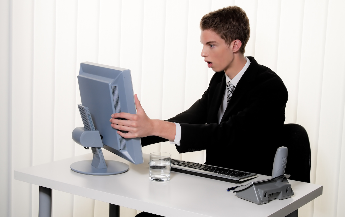 young man in a suit working at the computer - 2010