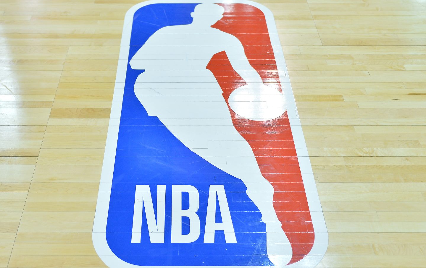 The NBA logo on a baskbeball court