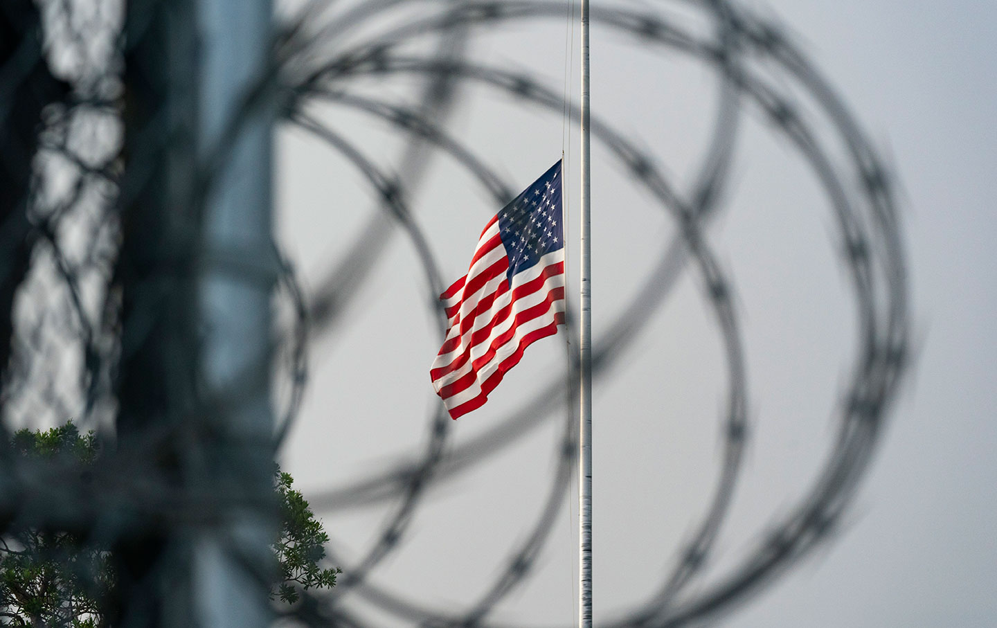 The American flag behind barbed wire