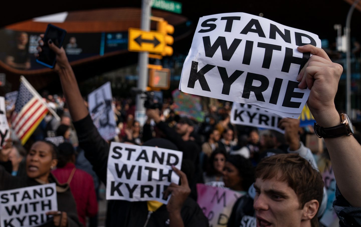 Protesters for Kyrie Irving holding signs