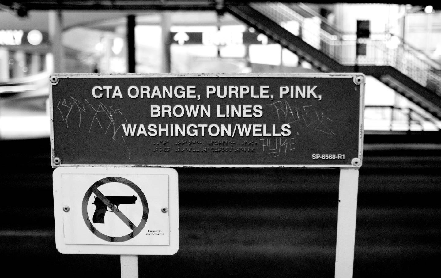 A sign showing that guns are not allowed, in black and white