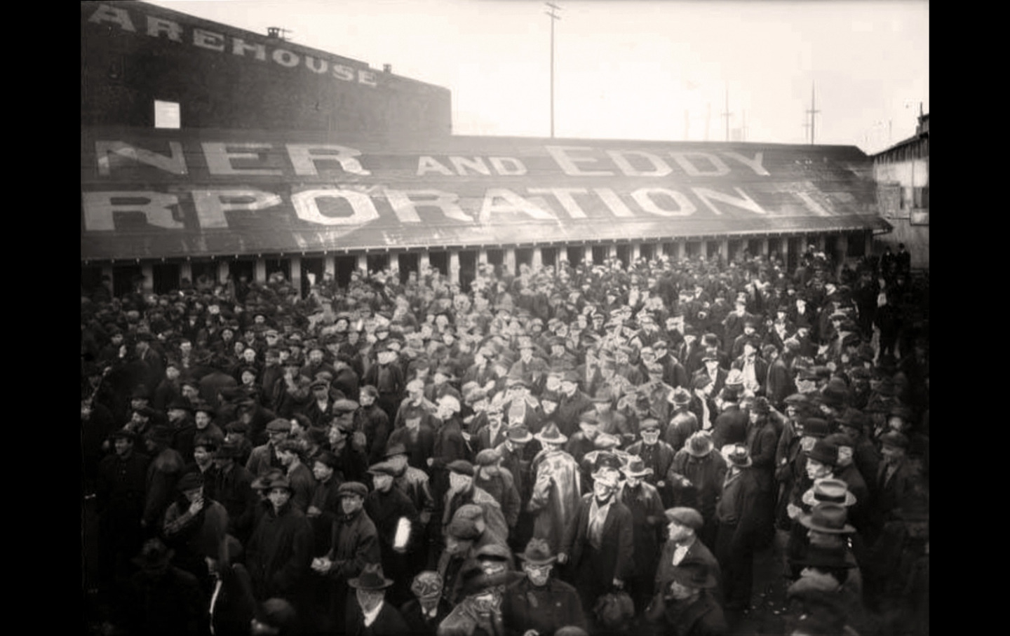 Workers participating in a general strike leave a shipyard.