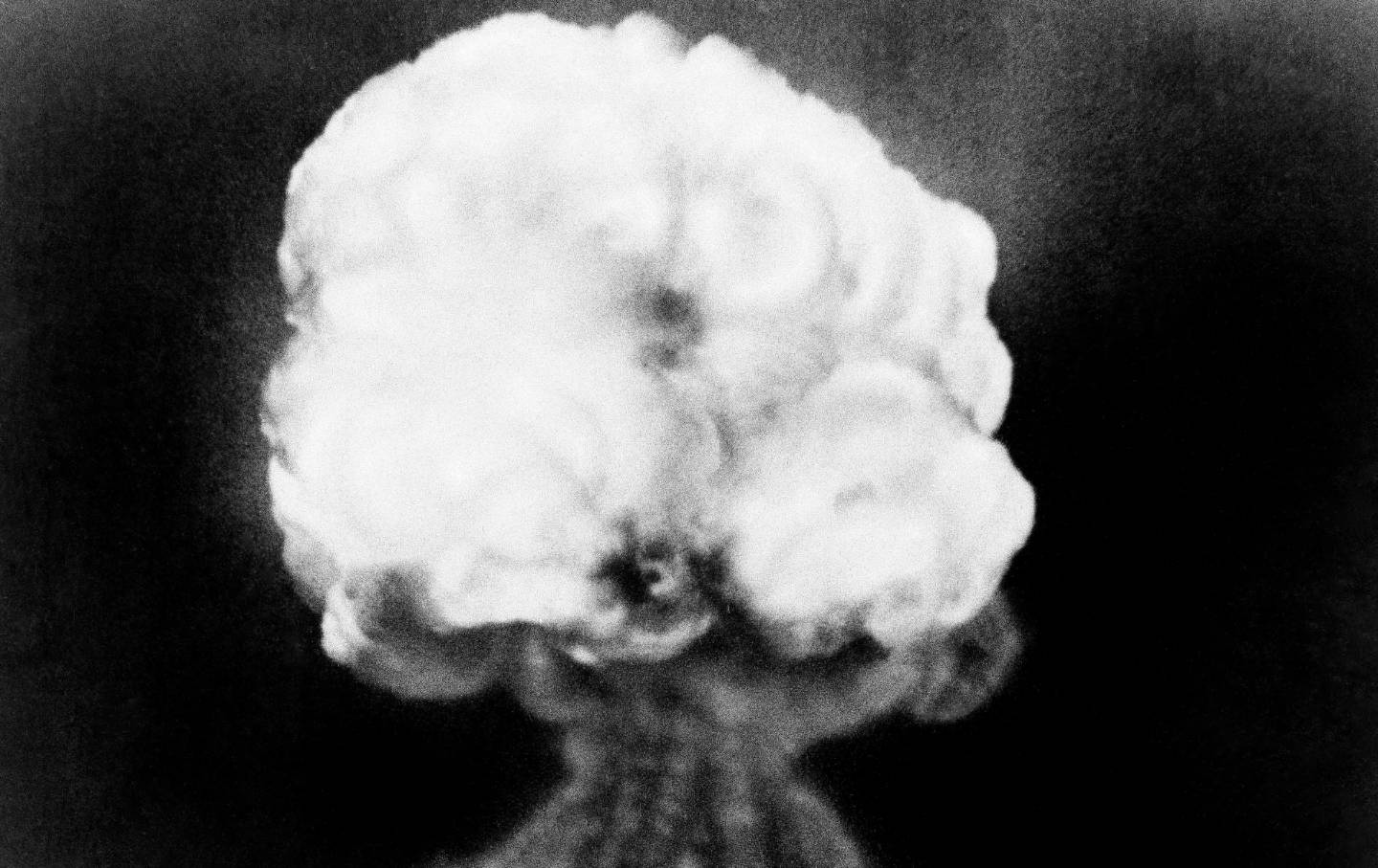 A black-and-white photo with a mushroom-shaped explosion.