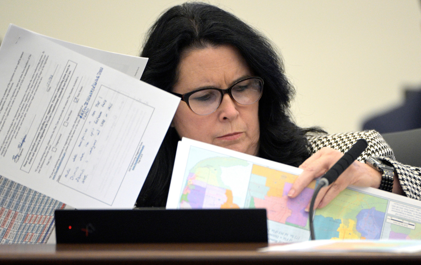 A woman looks through maps