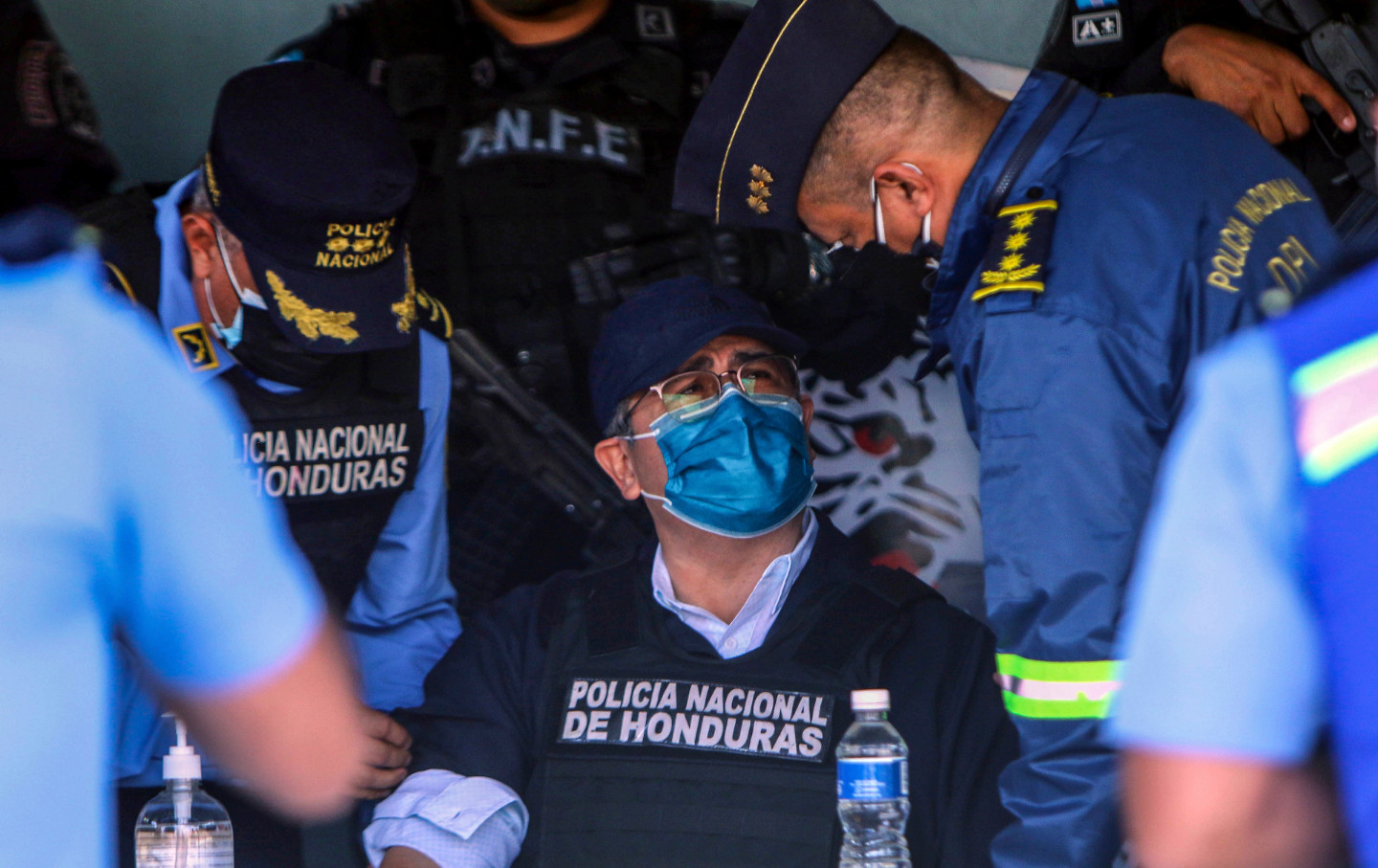 A man in a mask is surrounded by police