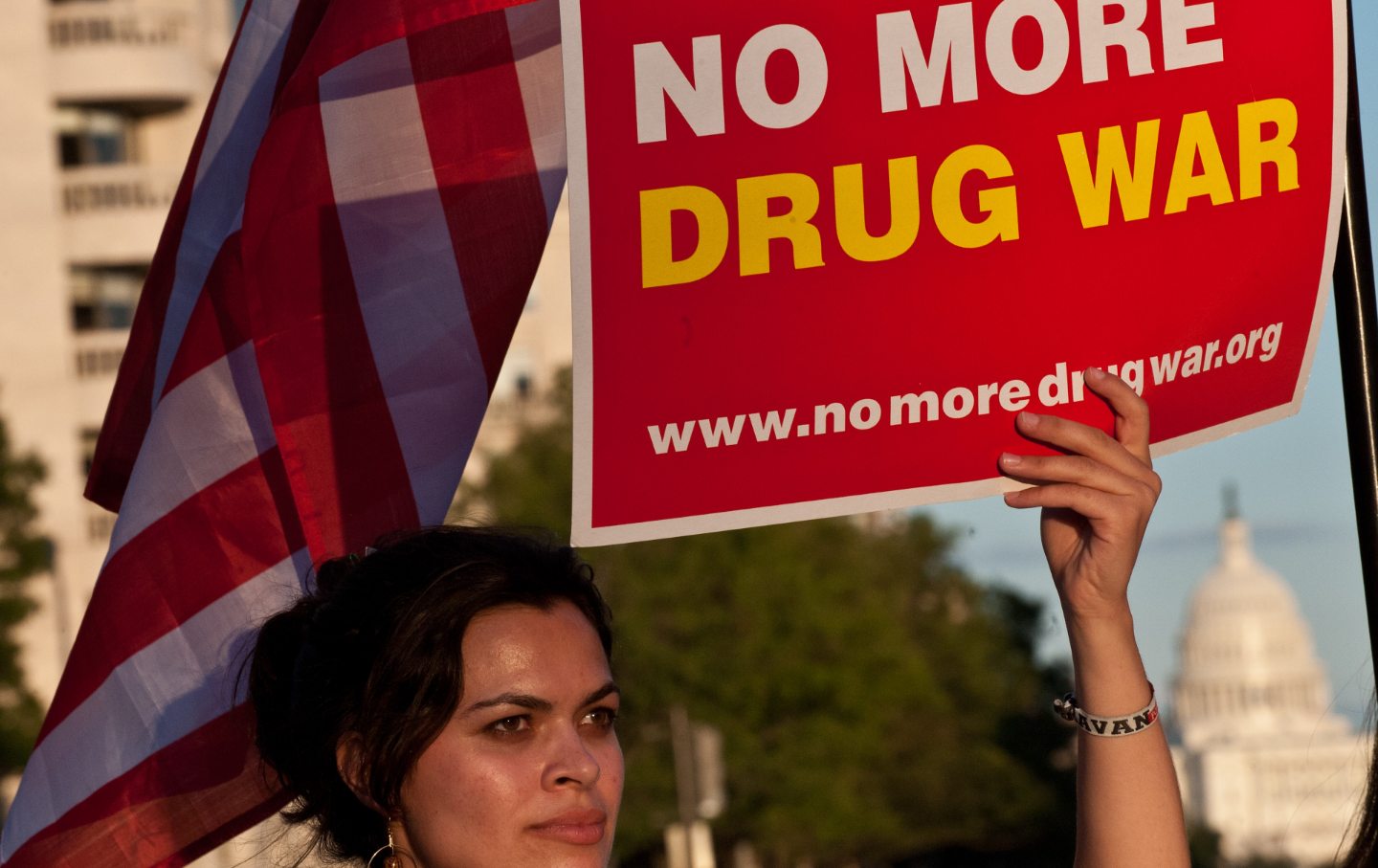 A woman holds a sign that says 