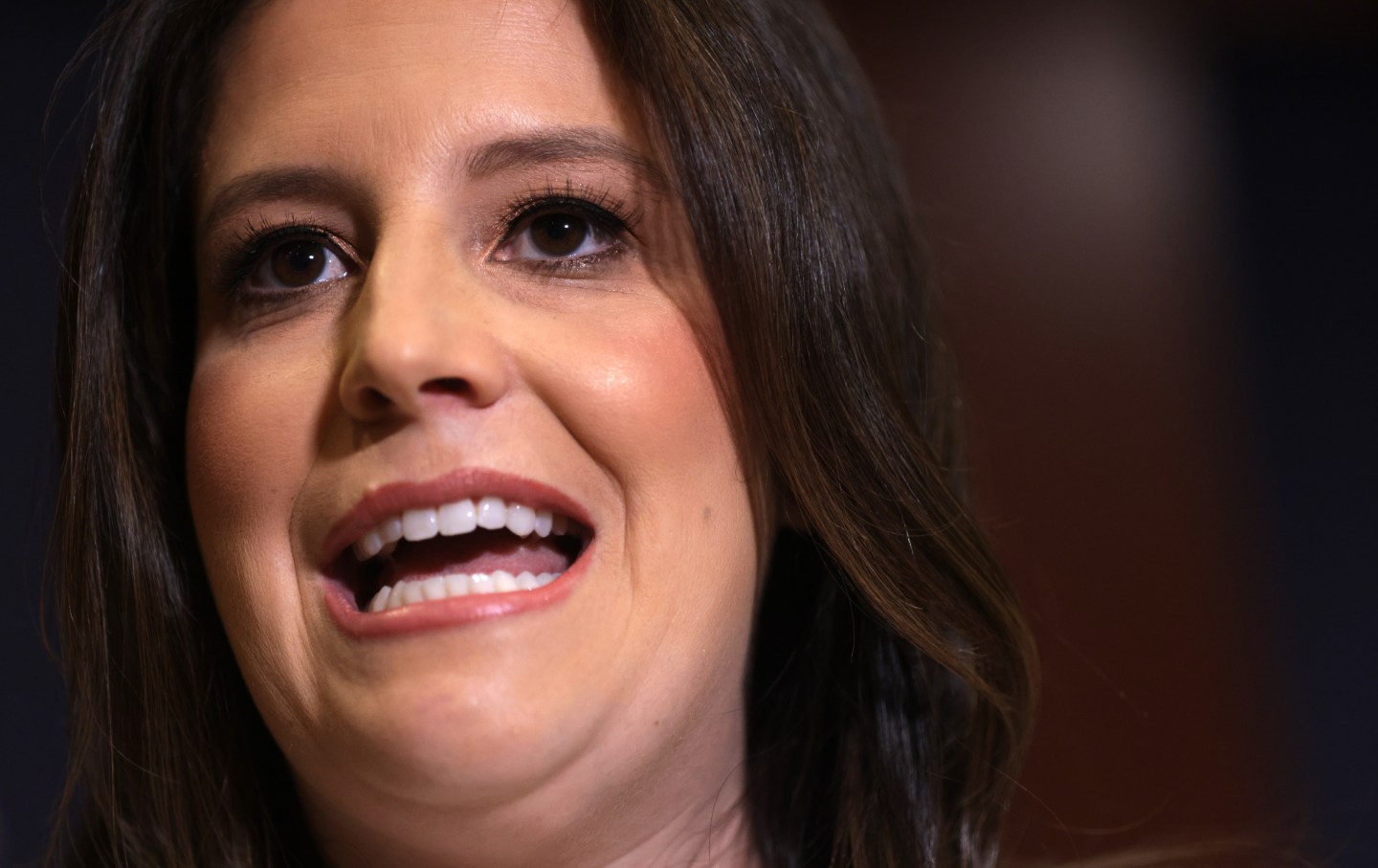 A closeup of a brown haired white woman talking