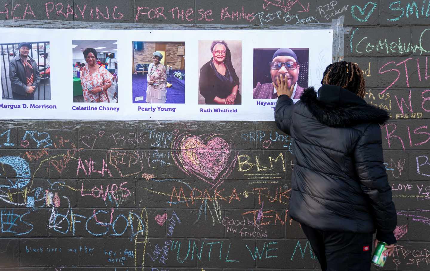 Woman touches memorial for Buffalo shooting