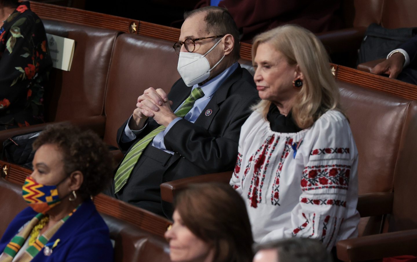 Two congresspeople sit next to each other during President Biden's State of the Union address.