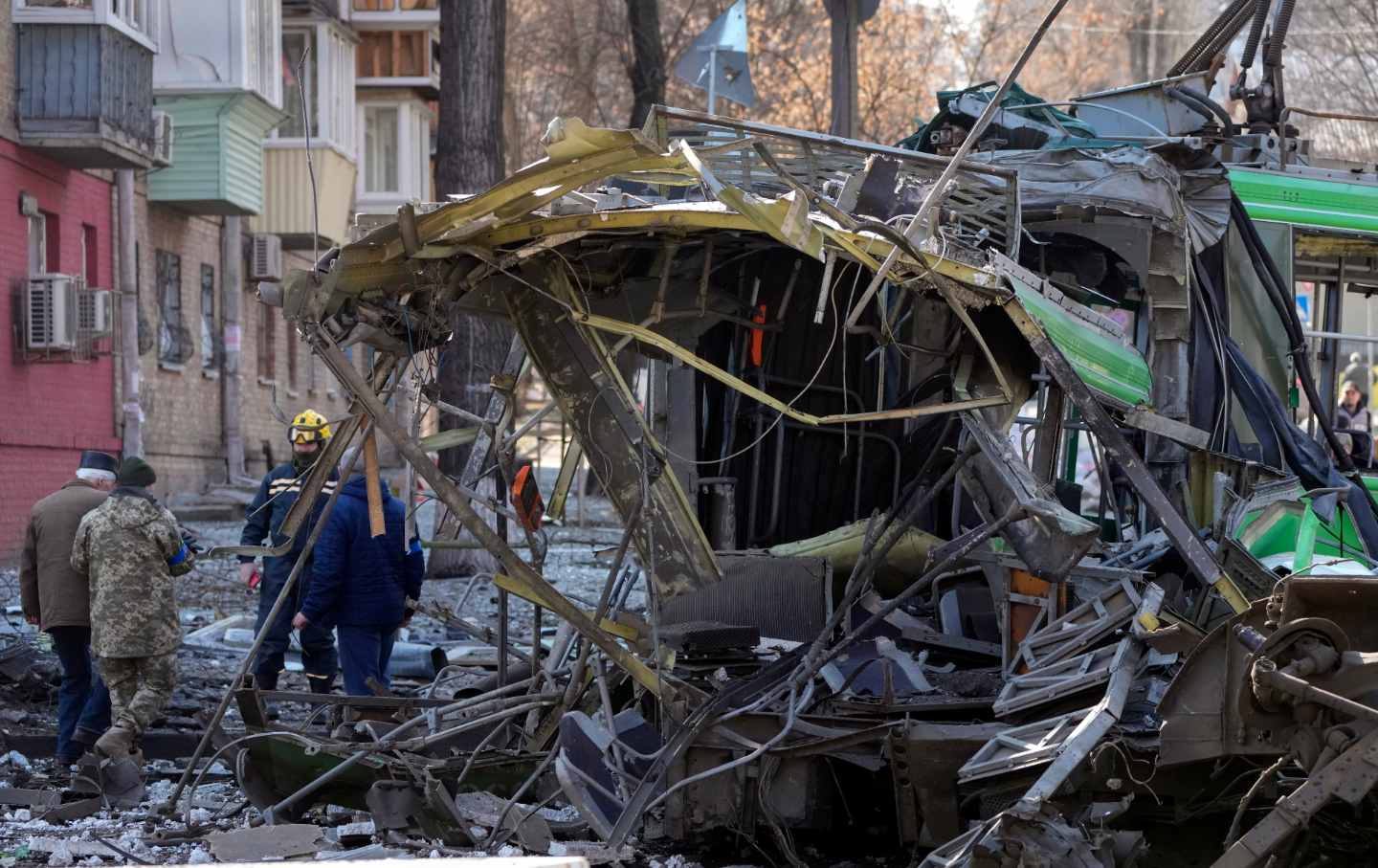 Men examine metal rubble