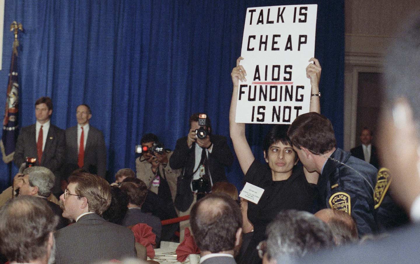 Urvashi Vaid holds up a sign that says 