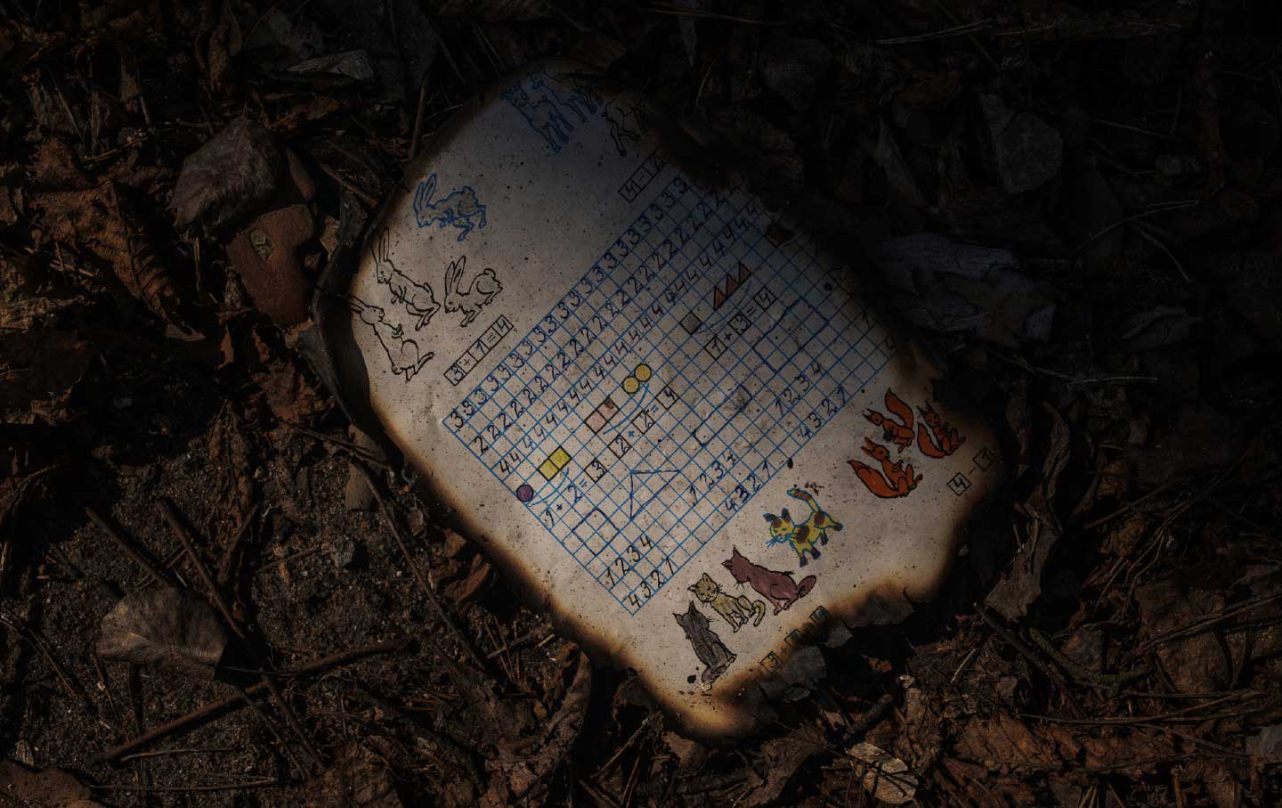 Charred schoolwork after a Russian bomb attack in Kyiv