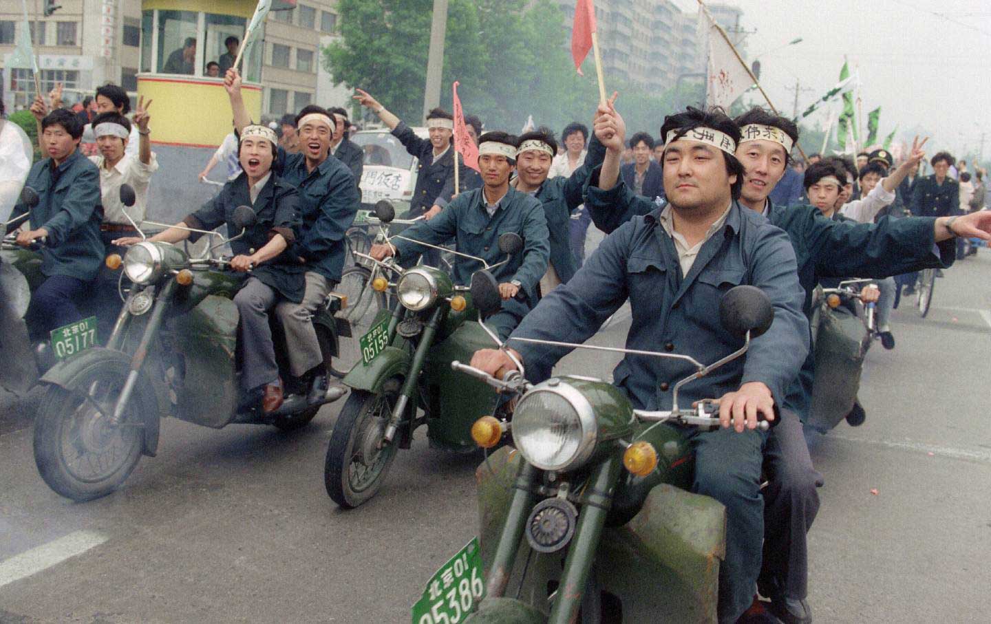 Workers on motorcycles protest Chinese government in 1989.