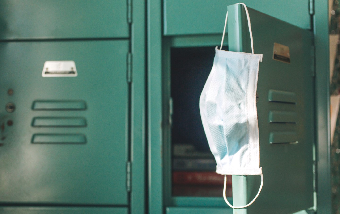 A mask hanging on a school locker