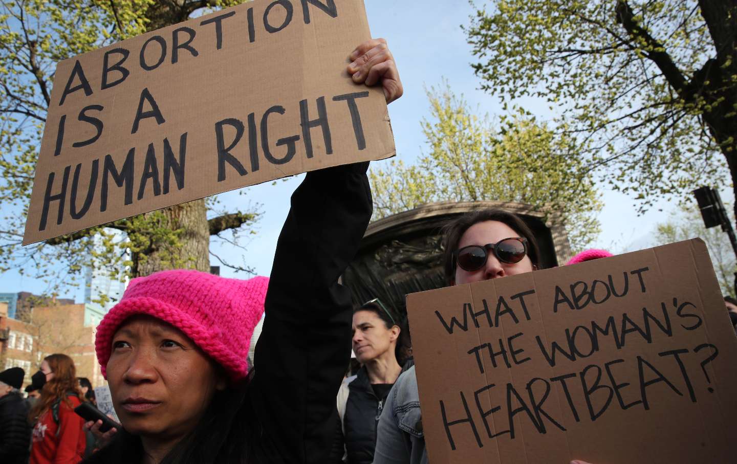 Protesters in Boston hold cardboard signs in support of abortion, one reads 