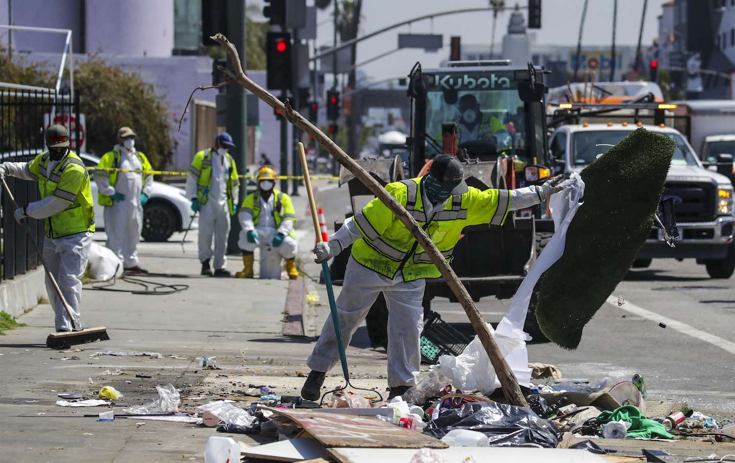An LA Sanitation Bureau crew cleans up a homeless encampment