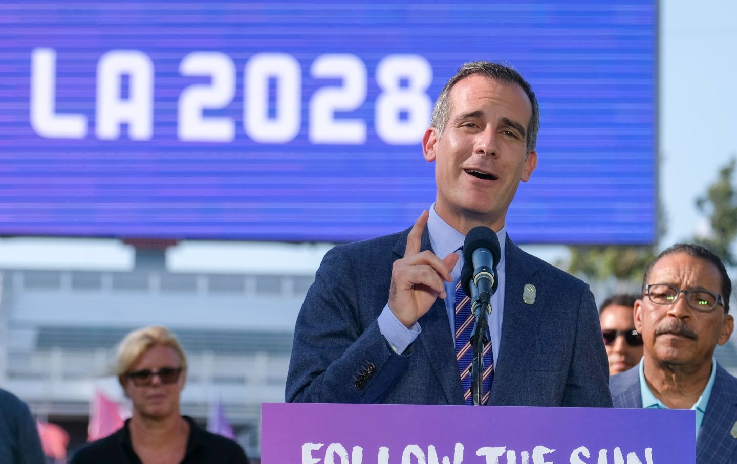 Los Angeles Mayor Eric Garcetti speaks in front a sign that reads, 