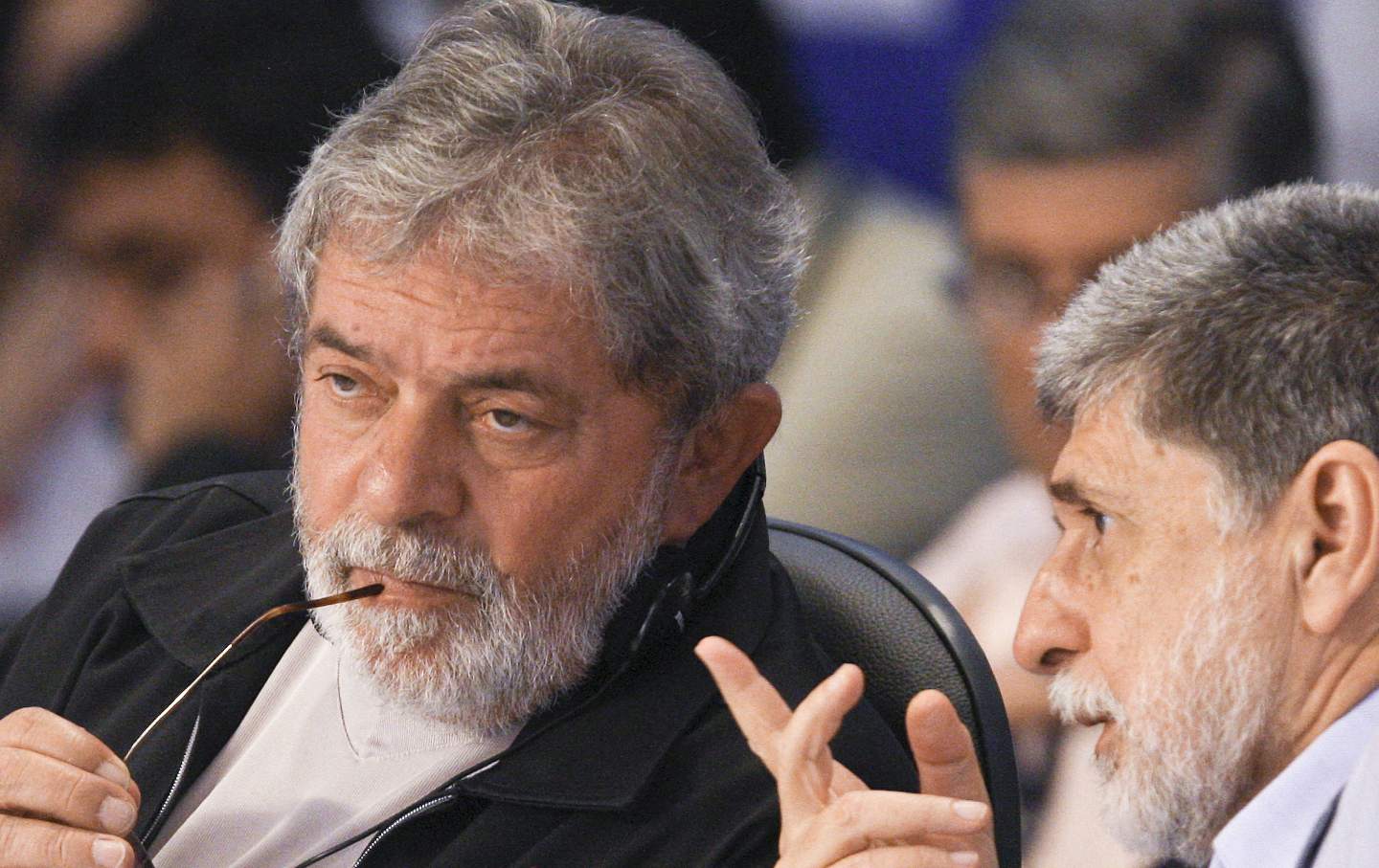 Brazil’s then-President Luiz Inácio Lula da Silva sits holding his glasses while he talks with his Foreign Affairs Minister Celso Amorim