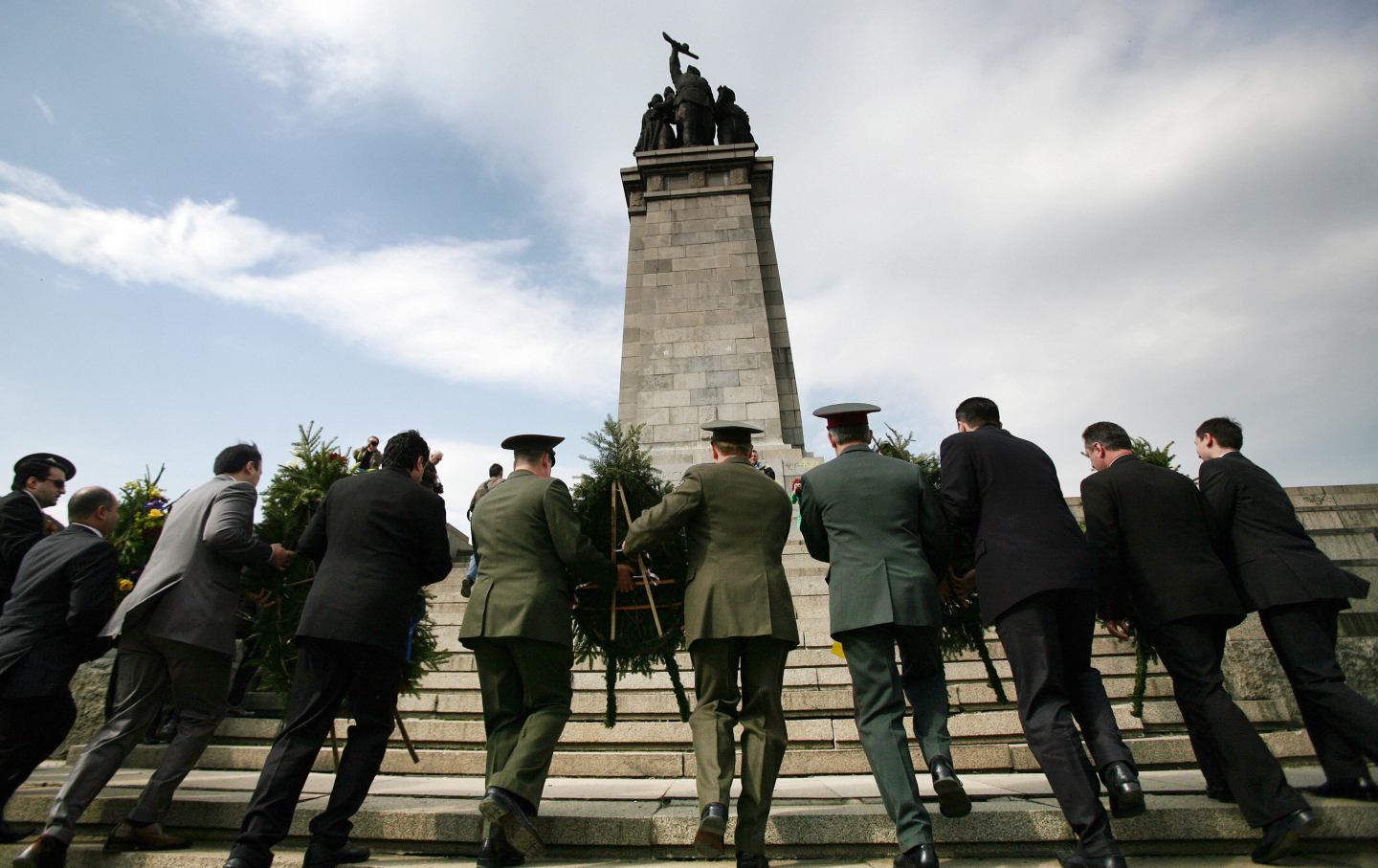 World War II veterans and military men pay their respect as they lay wreaths at the monument of the Soviet Army in central Sofia on May 9, 2008.