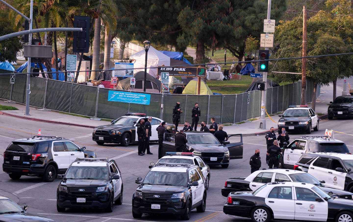 Police officers and their vehicles congregate in front of Echo Park in Los Angeles on March 25, 2021.