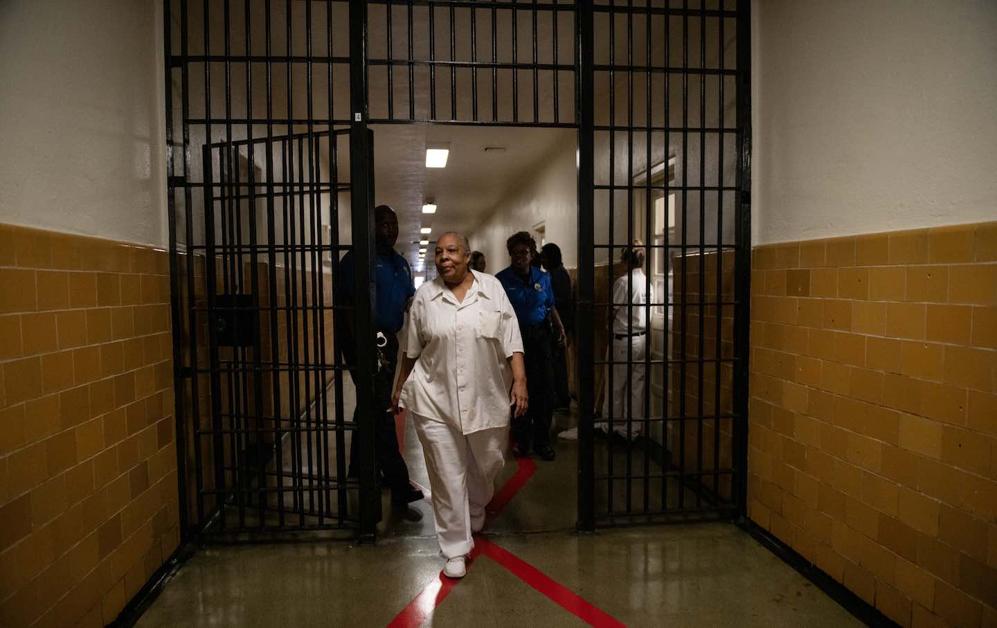 Geneva Cooley, 72, walks out the main gates to the Julia Tutwiler Prison