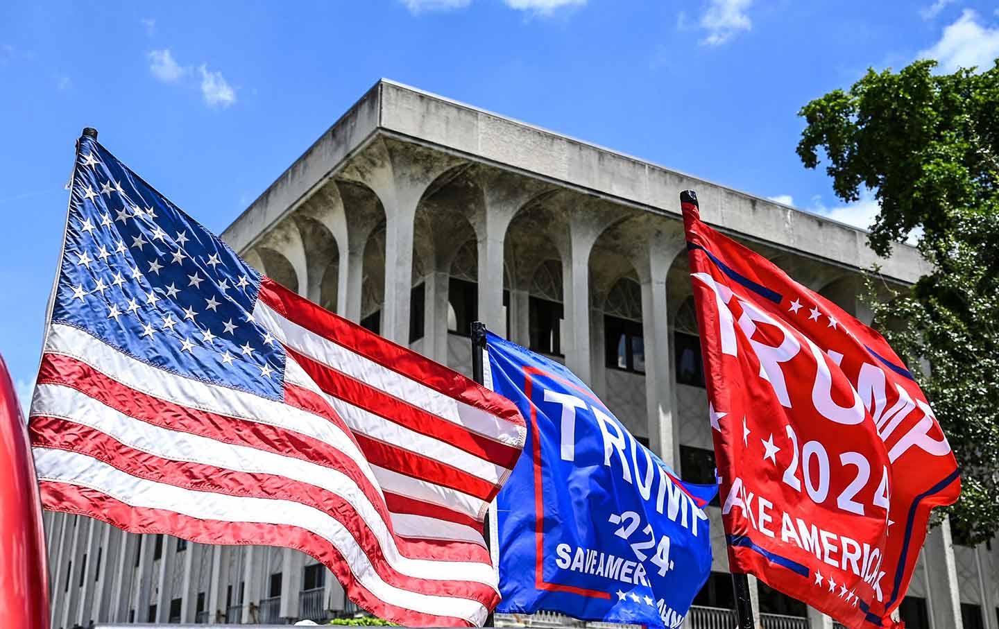 Supporters of former US president Donald Trump drive around the Paul G. Rogers Federal Building and Courthouse in West Palm Beach, Fla.