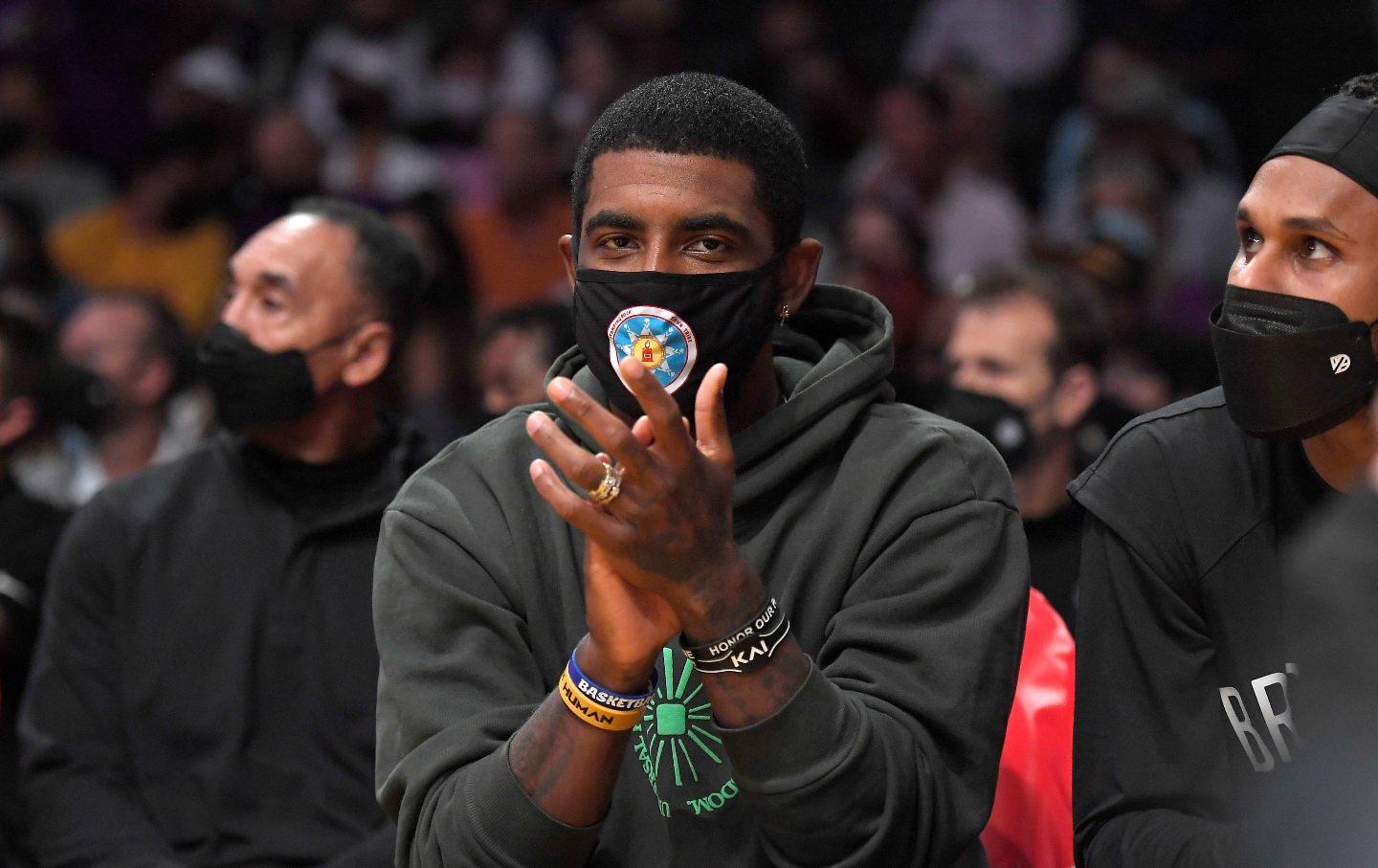 Brooklyn Nets basketball player Kyrie Irving claps looking into the camera at a pre-season game against the Los Angeles Lakers at Staplers Center in Los Angeles.