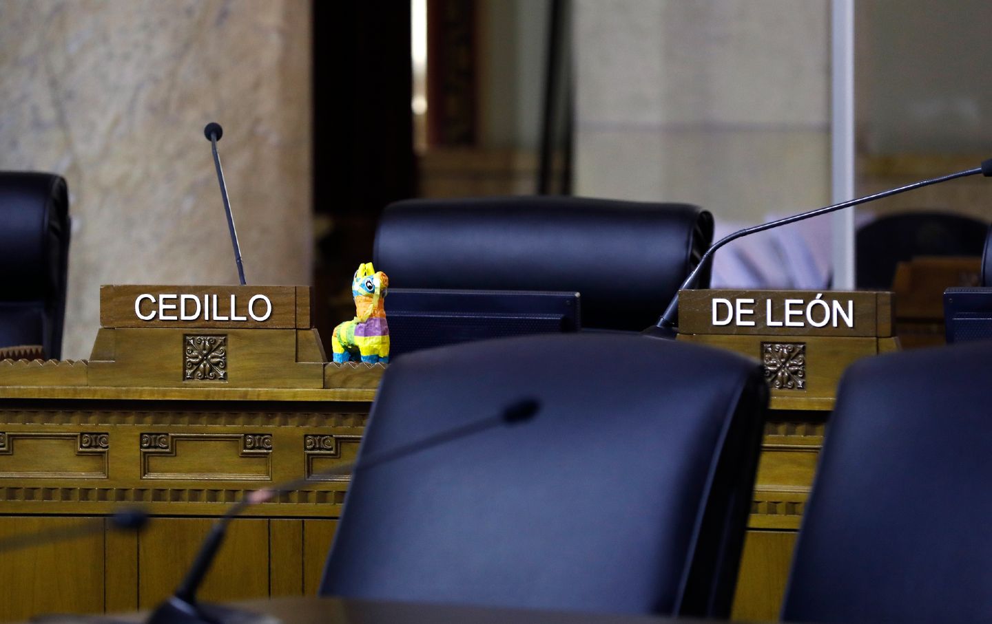 Councilman Gil Cedillo and Kevin de Leon's chairs sit empty at Wednesday's city council meeting.