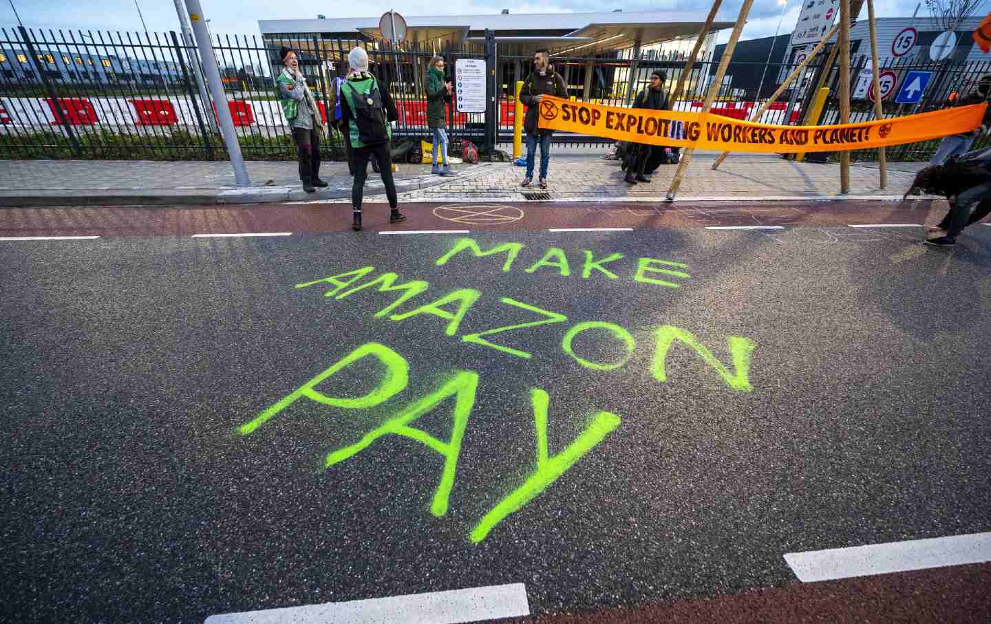 Extinction Rebellion climate activists block access to a Netherlands Amazon distribution center and spray paint 