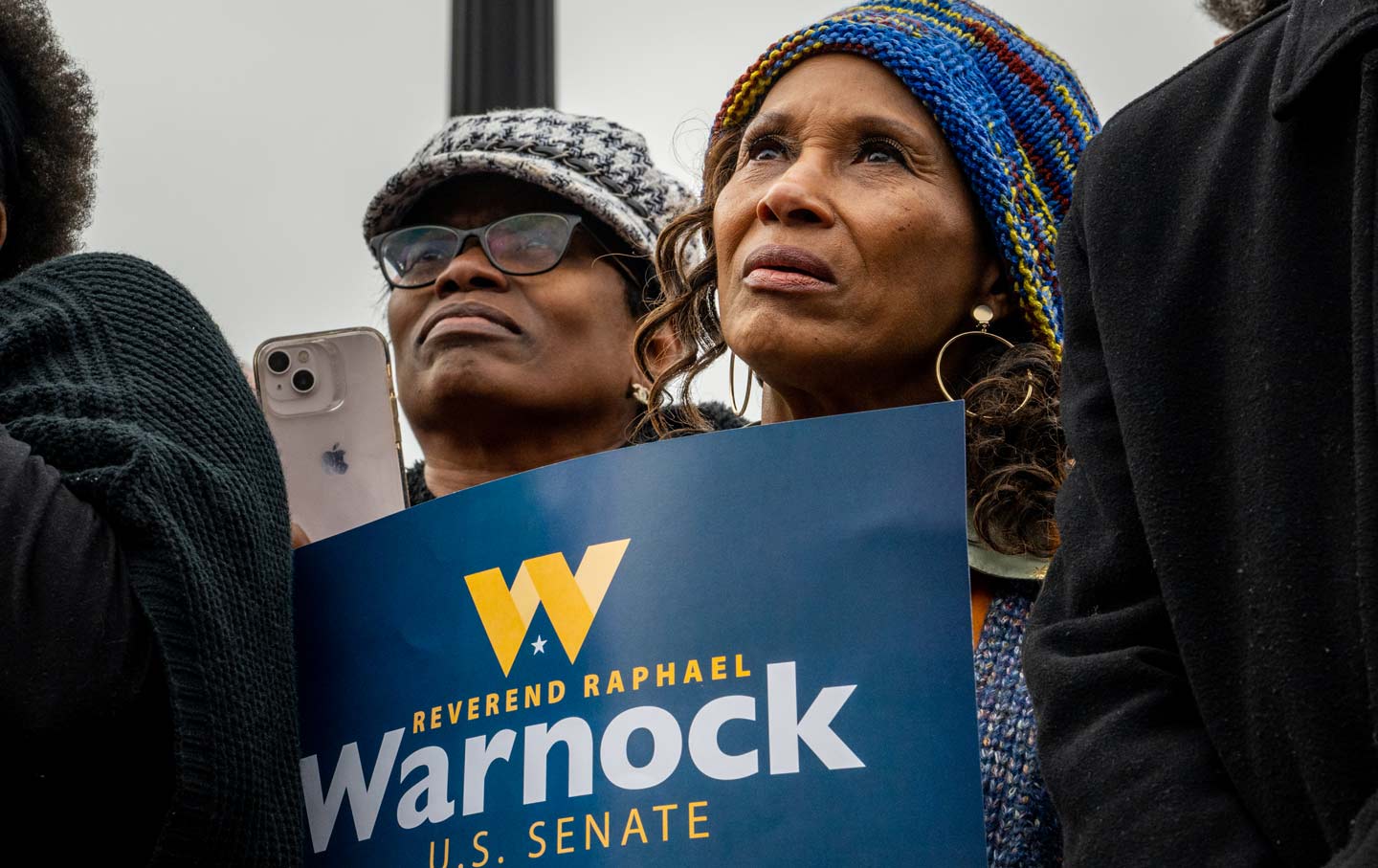 Two Black women at a rally for Sen. Raphael Warnock