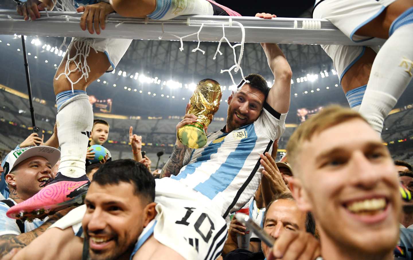 Argentina wins the 2022 FIFA World Cup. Lionel Messi celebrates with his team.