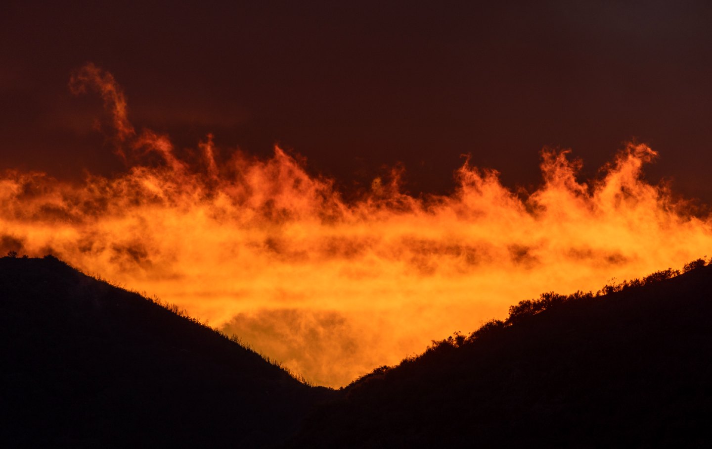 A storm in the Angeles National Forest looks like clouds on fire.