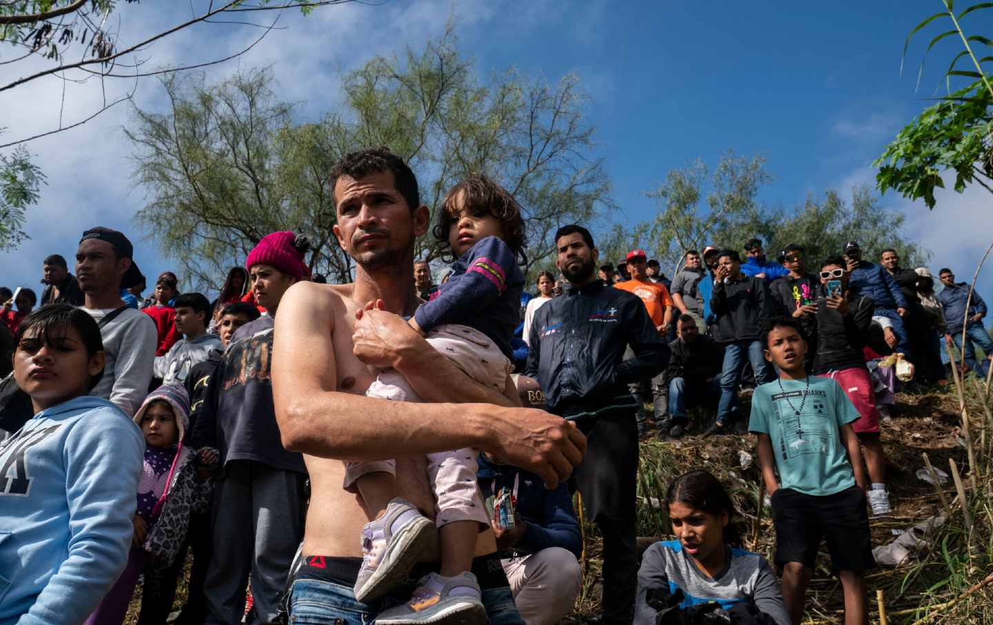 Venezuelan asylum seeker Jehan Carlo Ramirez carries his daughter across the Rio Grande into Brownsville, Texas.