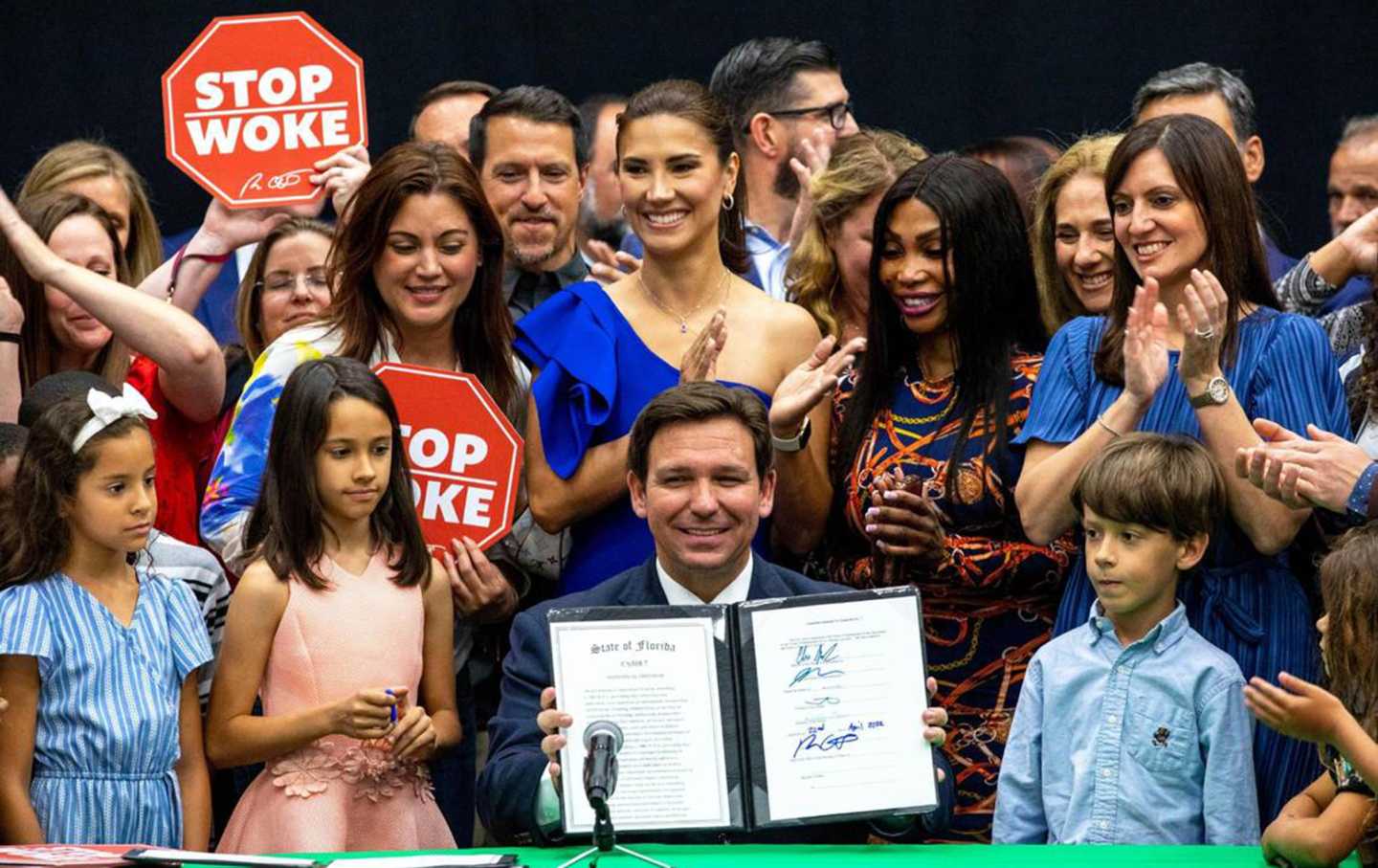 Ron DeSantis holding up HB7