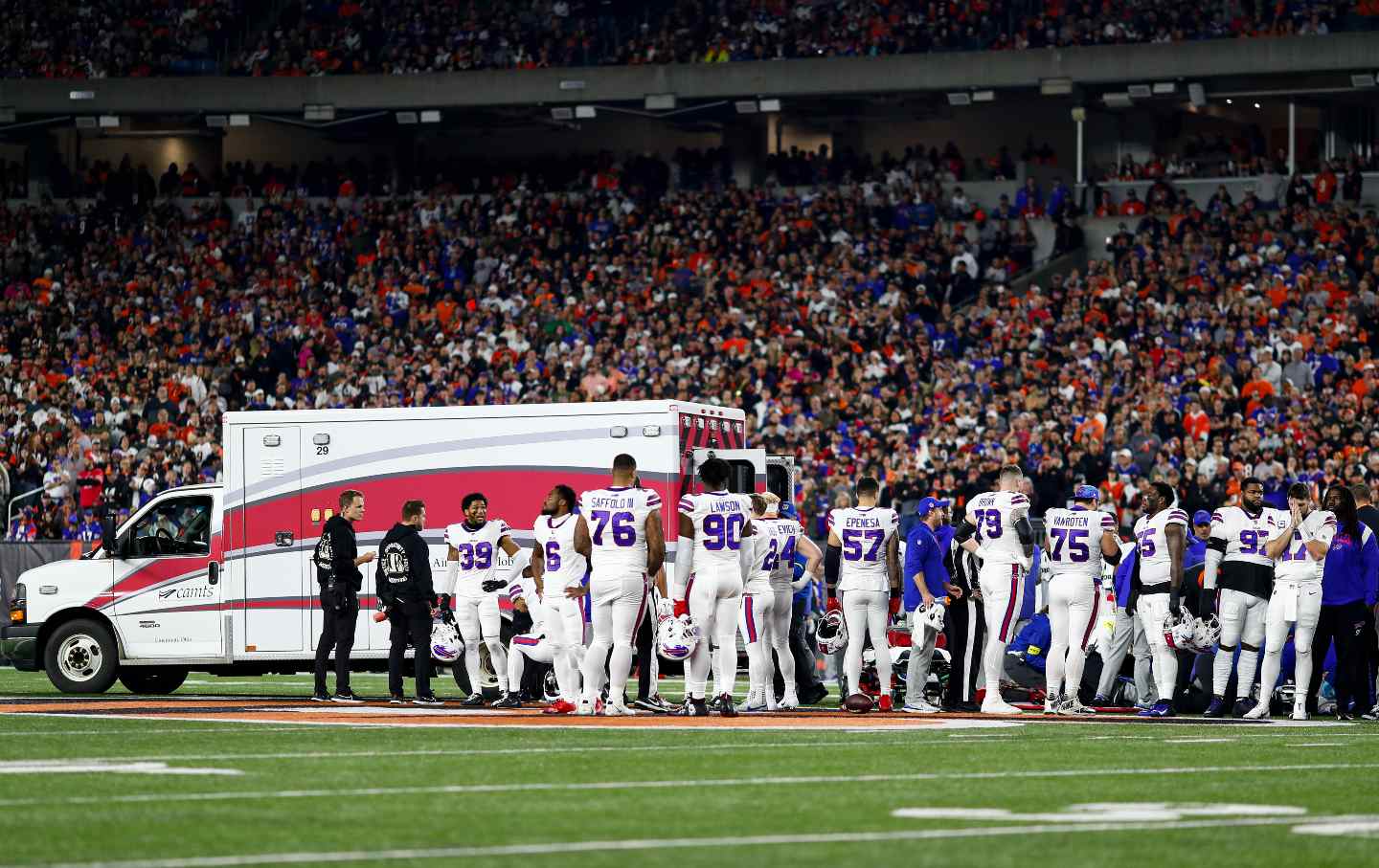 Buffalo Bills players react to an injury sustained by Damar Hamlin #3 with an ambulance on the field during the first quarter of an NFL football game against the Cincinnati Bengals at Paycor Stadium in Ohio.