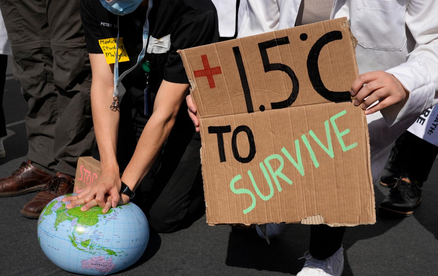 Demonstrators hold up signs and props at the 2022 COP27 U.N. summit