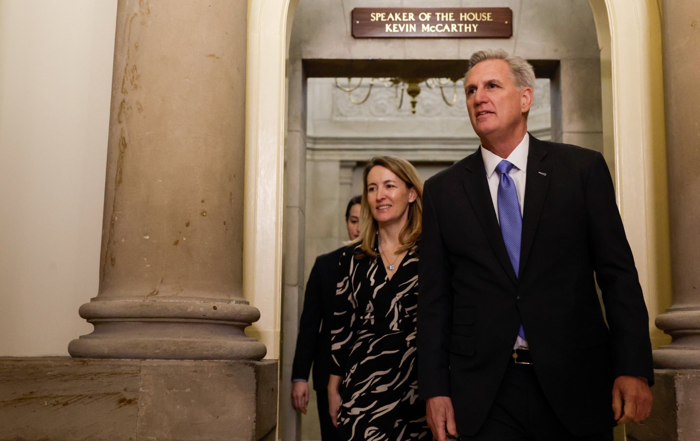 Kevin McCarthy under a sign that reads 