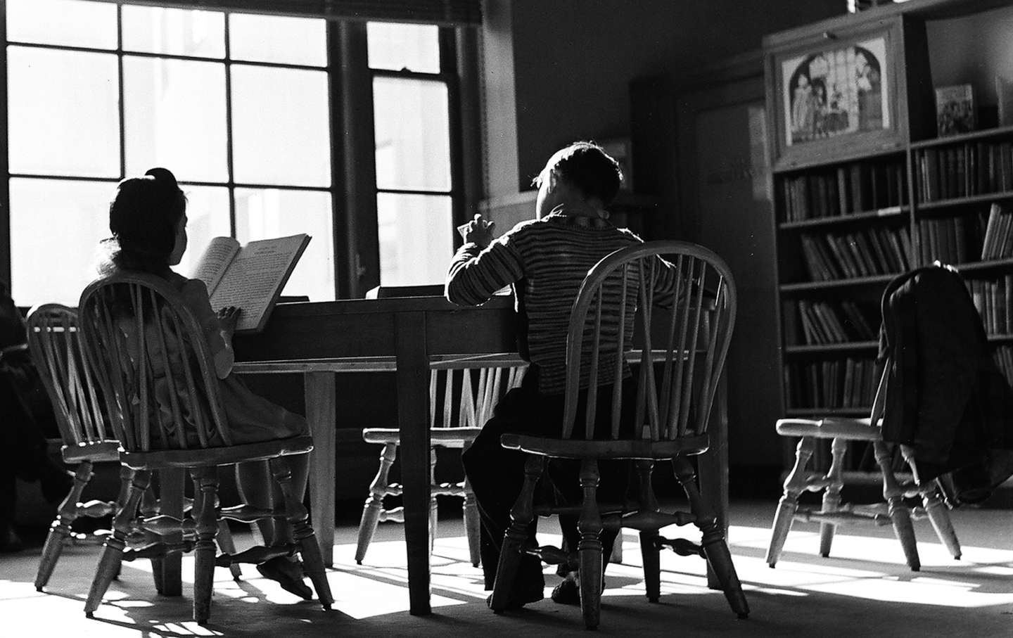 Children read books in a public library near Grand Army Plaza, Brooklyn, New York, New York, 1947.