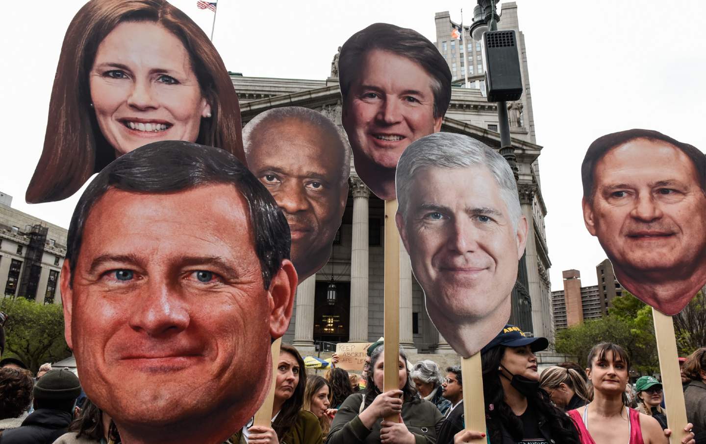 Demonstrators with signs of U.S. Supreme Court justices
