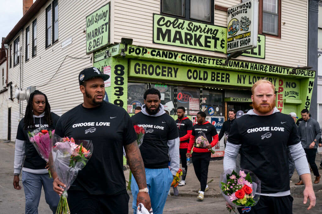 Bills players and staff walking to pay respects and show solidarity at the scene of the mass shooting on Buffalo’s East Side, May 18, 2022.