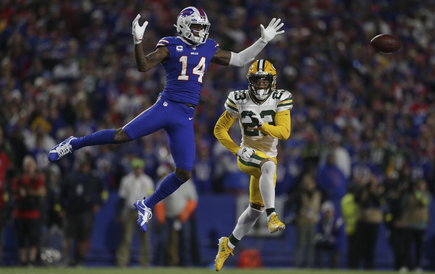 Stefon Diggs, #14 of the Buffalo Bills, leaps for a pass, with Jaire Alexander, #23 of the Green Bay Packers, in pursuit, October 30, 2022. (Joshua Bessex / Getty Images)