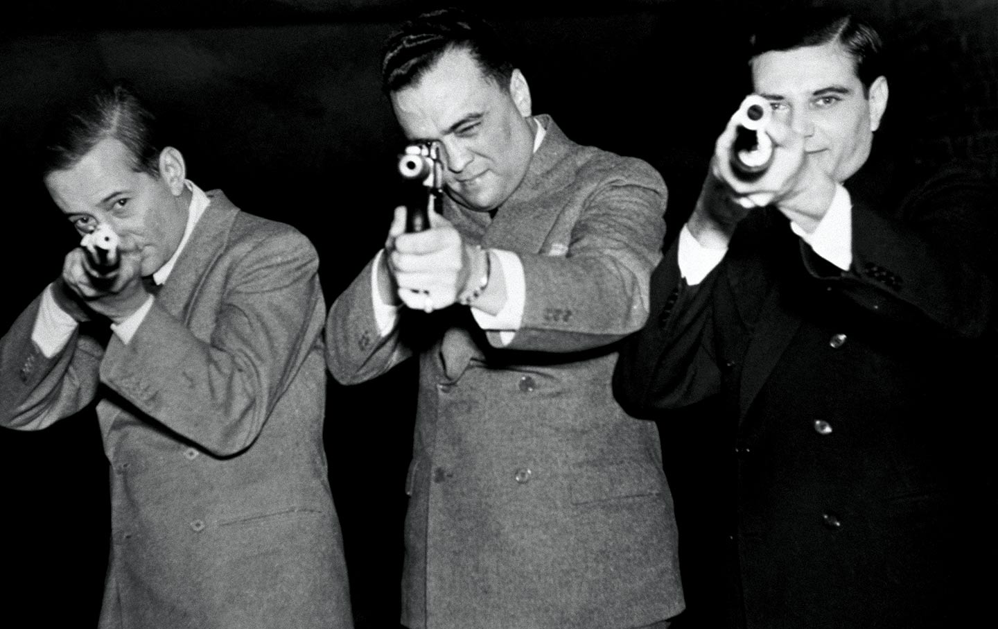 J. Edgar Hoover tests a gun.