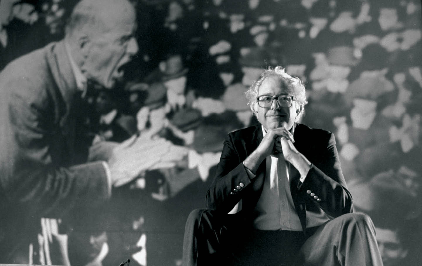 Newly elected US Representative Bernie Sanders poses in front of an image of labor leader Eugene V. Debs