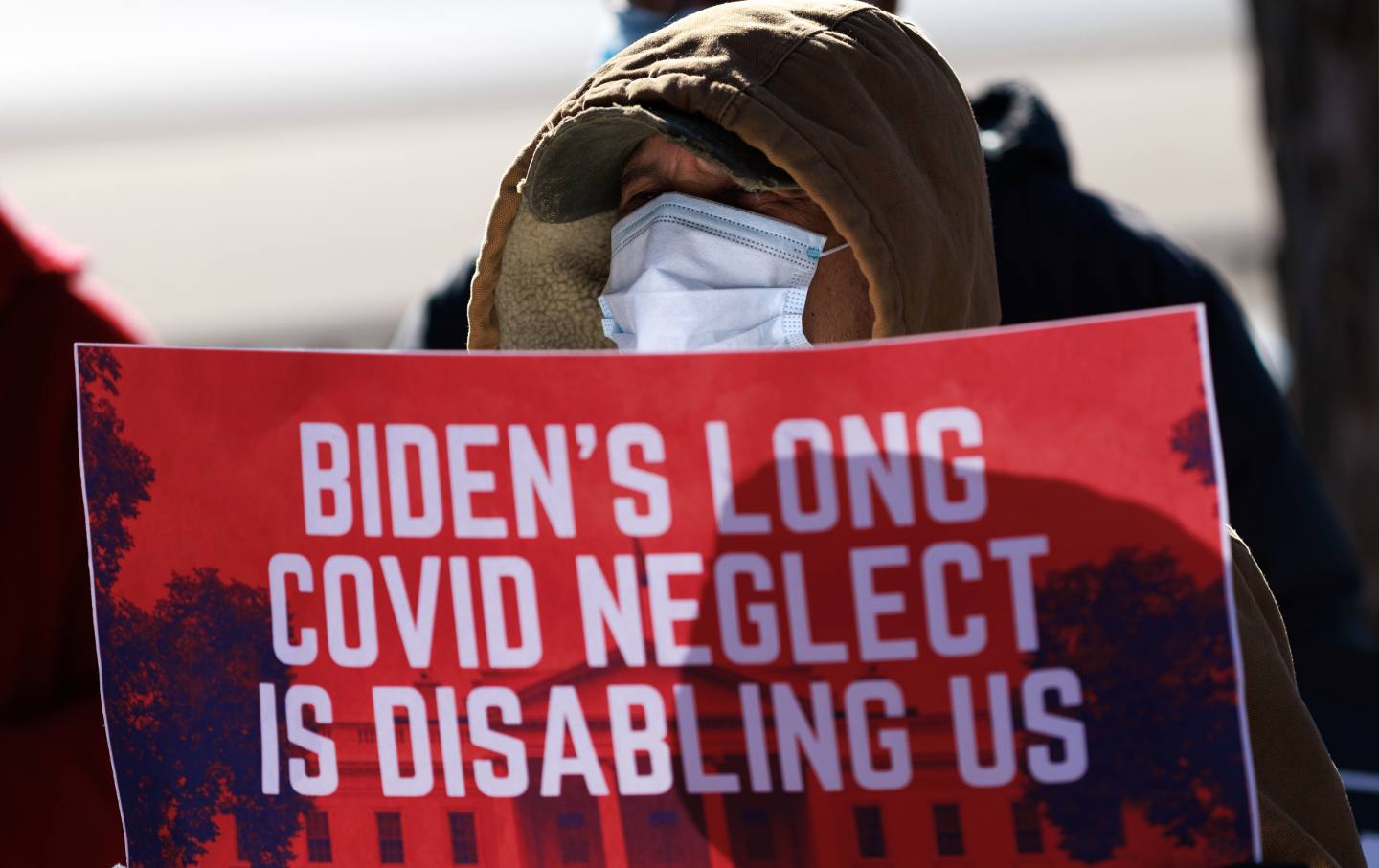 person holding protest sign that says 