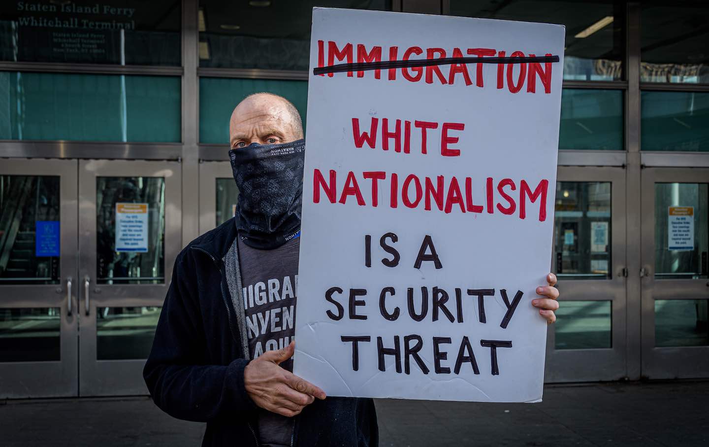 Participant seen holding a sign at a protest of current US immigration policy
