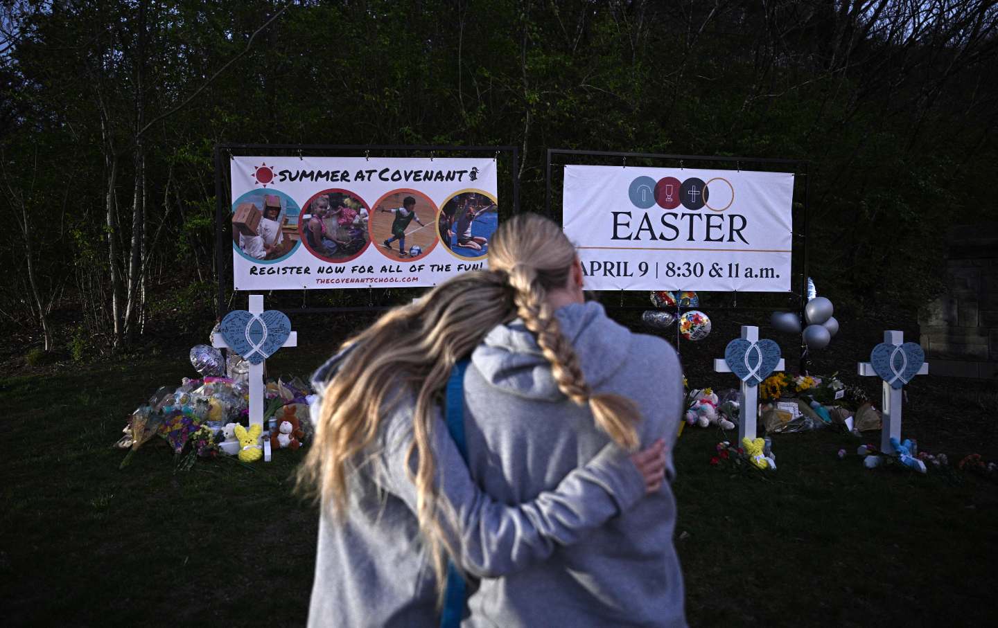 People gather at a makeshift memorial for victims of the shooting at the Covenant School campus in Nashville, Tenn., on March 28, 2023.