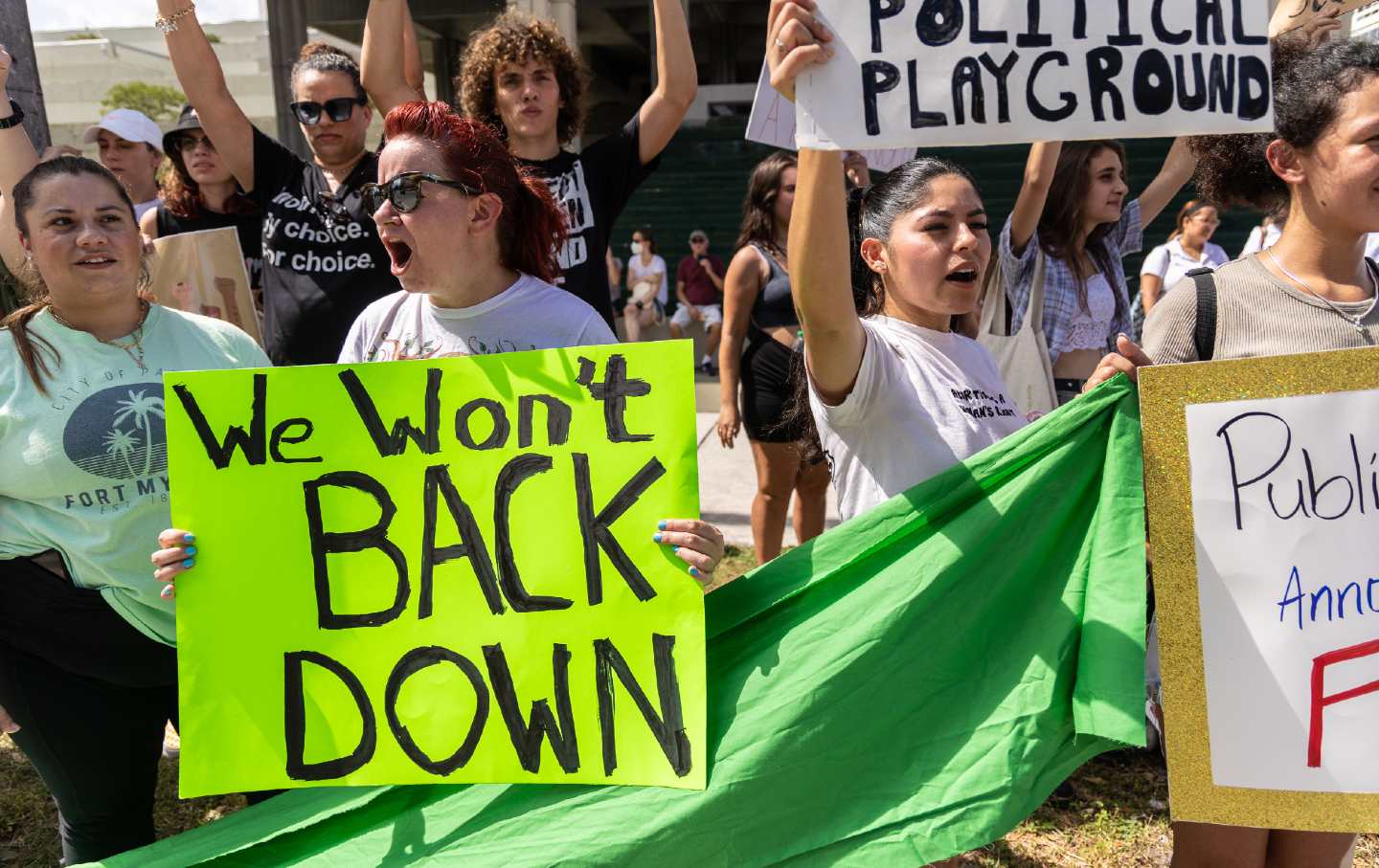 Protester holding sign with Tom Petty lyrics supporting abortion access