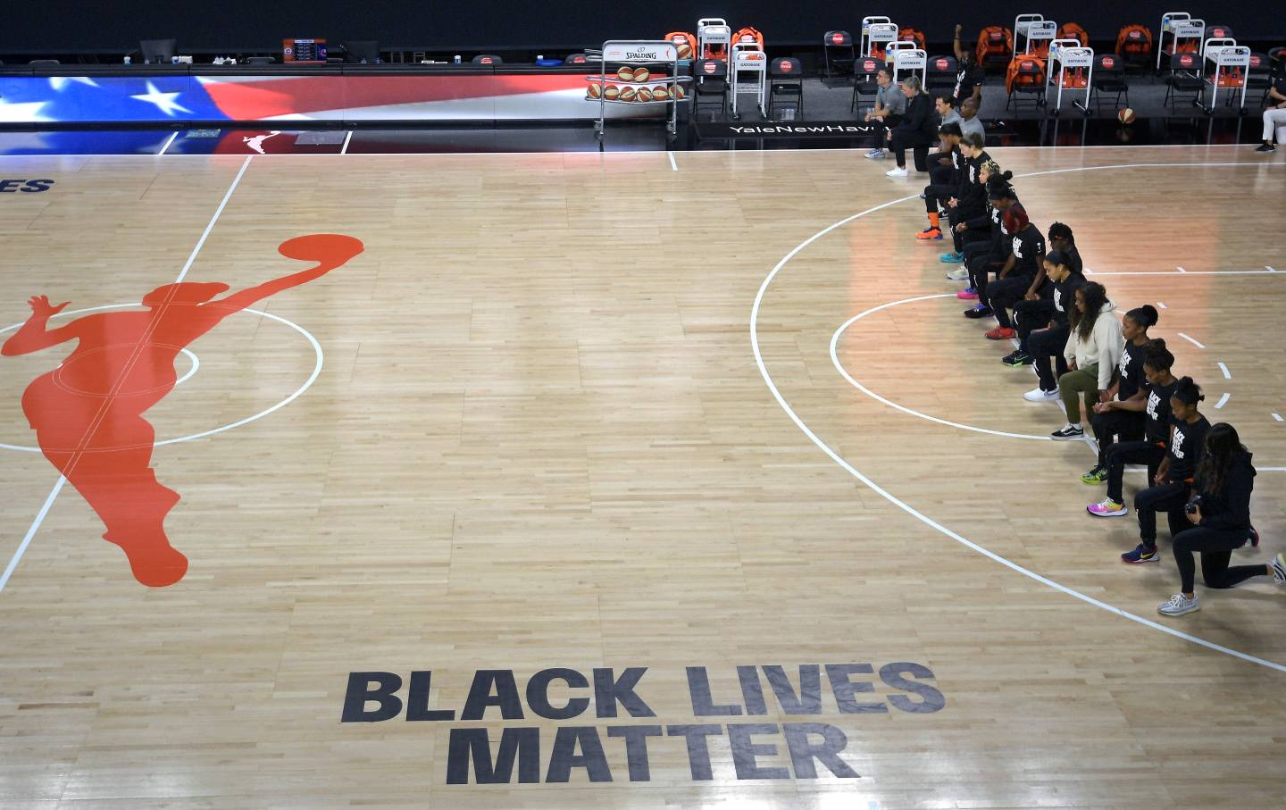 members of the Connecticut Sun team kneel during the playing of the national anthe